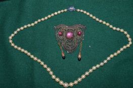 Pearl necklace and a decorative pendant.