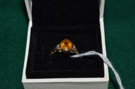 A 9ct gold and gem set ring, possibly Citrine.