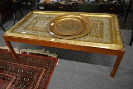 An Eastern engraved brass tray top coffee table and two engraved brass trays.
