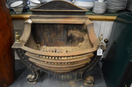 A Regency style cast iron fire grate.