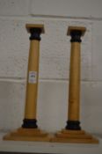 A pair of stylish wooden candlesticks.