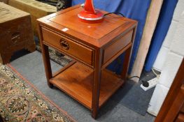 A Chinese redwood two-tier single drawer occasional table.