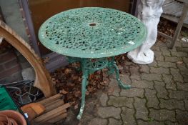 A green painted cast metal garden table.