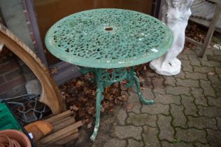 A green painted cast metal garden table.