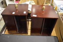 A pair of table top revolving CD racks.