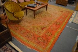 An Indian carpet, orange ground with stylised decoration, 410cm x 305cm.