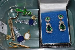 A pair of decorative earrings and other jewellery.