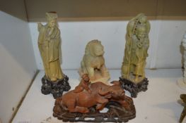 Chinese carved wood boy on an oxen together with three soap stone figures.