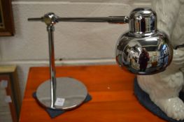 A pair of chrome plated adjustable desk lamps.