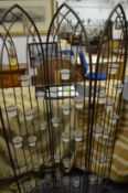 A wrought iron floor standing screen style T light holder.