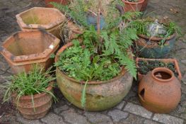 A quantity of terracotta plant pots etc.