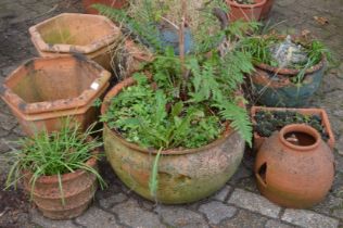 A quantity of terracotta plant pots etc.