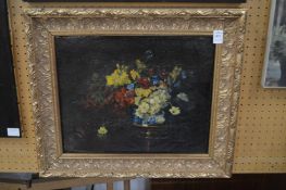 A still life of flowers in a vase on a table, oil on canvas in a decorative gilt frame.