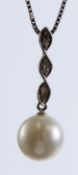 AN 18CT WHITE GOLD, PEARL AND DIAMOND PENDANT AND CHAIN.