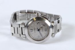 A CARTIER AUTOMATIC WRISTWATCH in a red Cartier box.