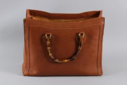 A GUCCI VINTAGE TAN LEATHER BAG with bamboo handles. No. 002-185-0259. 44cms long. Sold with