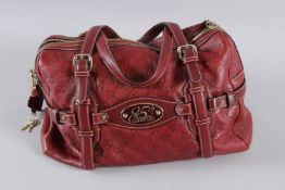 A RED GUCCI SOFT LEATHER BAG and 85th plaque. 35cms high, with dust cover. Sold with