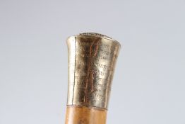 A WALKING CANE with gold handle. 88cms long.