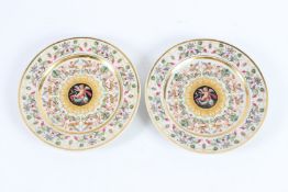 A PAIR OF KPM PLATES with cupids and dolphins. 20cms diameter.