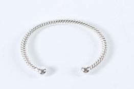 A STERLING SILVER TWISTED TORQUE BANGLE.