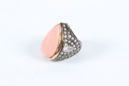 A SILVER CORAL AND DIAMANTE TEAR DROP RING.