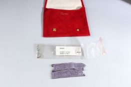 A CARTIER LEATHER WATCH STRAP in a suede pouch.
