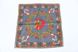 A MOSCHINO FLORAL SILK SCARF. 45cms x 45cms.