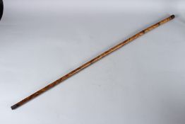 A WALKING CANE with twist off handle. 88cms long.