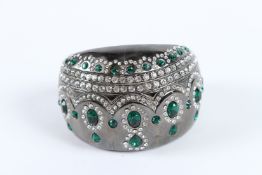 A GOOD DIAMANTE GREEN STONE BANGLE, signed.