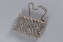 A VINTAGE ESCADA SILVER G LETTER EVENING BAG with gilt strap. 19cms long, with dust bag.
