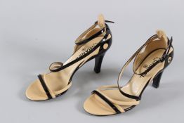 A PAIR OF CHANEL PATENT SLIP-ON SHOES, black and tan. Size 38.5.
