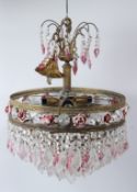 AN ORNATE ORMOLU, CLEAR AND COLOURED GLASS CHANDELIERS, with cut glass drops and porcelain rosebud