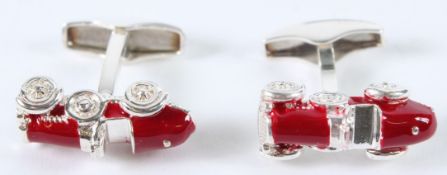 A PAIR OF STERLING SILVER AND ENAMEL CAR CUFFLINKS.
