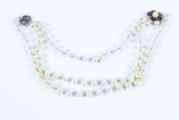 A VERY GOOD CHANEL DOUBLE ROW PEARL NECKLACE with enamel and gilt clasp.