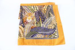 A SALVATORE FERRAGAMO TIGER SILK SCARF in original box.