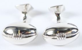 A PAIR OF STERLING SILVER RUGBY BALL CUFFLINKS.