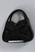 A GUISEPPE ZANOTTI BLACK EVENING BAG. 22cms long.