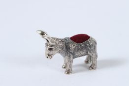 A SILVER DONKEY PIN CUSHION.