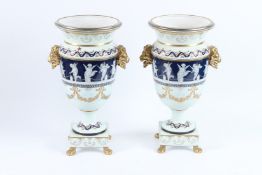 A GOOD LARGE PAIR OF CONTINENTAL PORCELAIN URNS with gilt lion handles and a and of cupids in