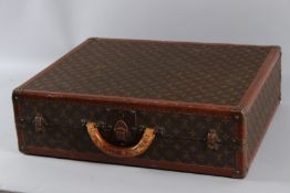 A LOUIS VUITTON SUITCASE No. 124941. 60cms x 50cms wide x 17cms deep.