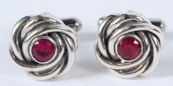 A PAIR OF SILVER AND RUBY KNOT CUFFLINKS.