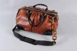 A LOUIS VUITTON BROWN LEATHER BAG with black trim and handles. 37cms long, with dust bag. Sold