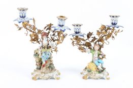 A GOOD CAPODIMONTE PORCELAIN PAIR OF CANDLESTICKS, a young boy and girl with gilt flowers.