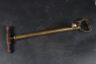 A BRASS PUMP, The Rotex Company, with wooden handle. 60cms high.