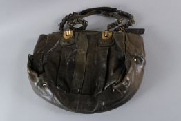 A CHLOE GREEN LEATHER BAG. 40cms high.
