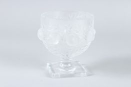 A LALIQUE CIRCULAR BOWL with chubby birds on a square base. 12cms high. Engraved Lalique, France.