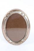 A SILVER OVAL PHOTOGRAPH FRAME. 20cms x 12cms.