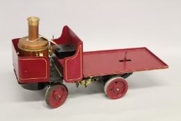 A MODEL OF A METHYLATED SPIRIT FIRED STEAM LORRY. 37cms x 64cms.