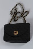 A VINTAGE CHANEL CLOTH EVENING BAG with gilt and stone clasp. 20cms long, with dust cover. Sold with