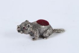 A SILVER BEAVER PIN CUSHION.